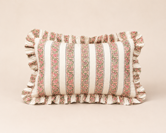 Blush Pink Rectangle cushion fabric lines a bread basket with fresh baguettes, its red scalloped edge visible against a pink table setting.
