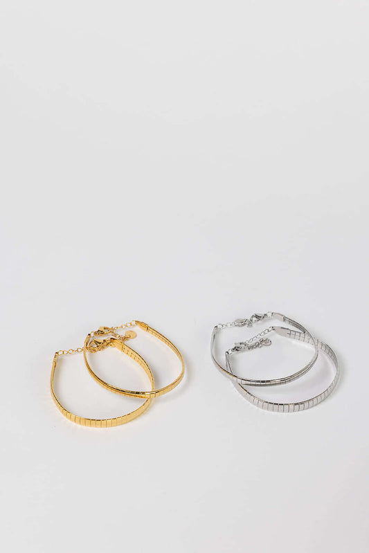 Braided Babe BRACELET flat omega-link chain bracelets shown in both gold and silver, studio flat-lay on white.