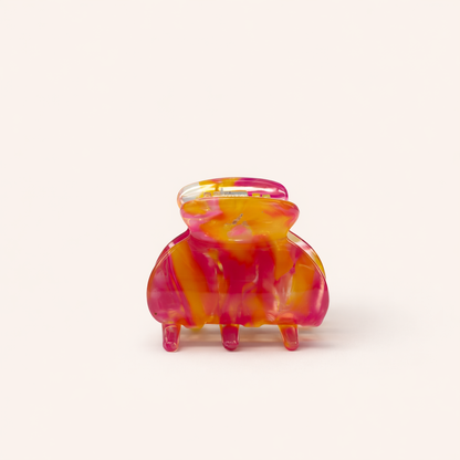 Bubblegum HAIR CLIP small acetate claw clip in a pink and orange marbled pattern, studio shot.