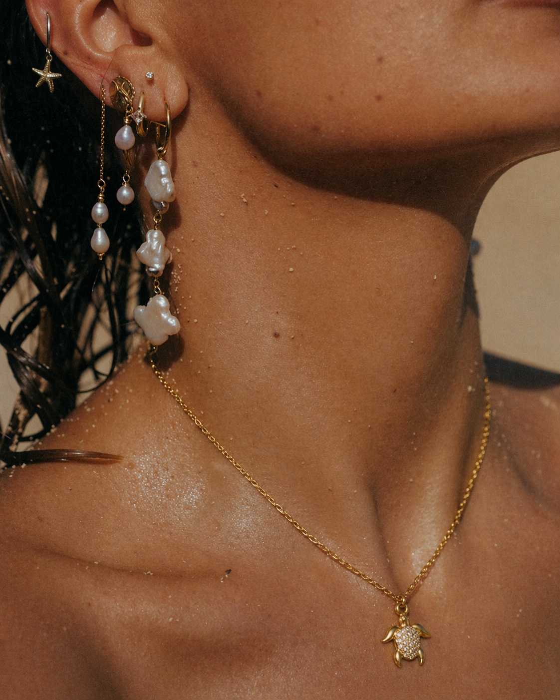 The By The Sea NECKLACE in the pave turtle style, worn on wet skin at the beach alongside layered pearl drop earrings.