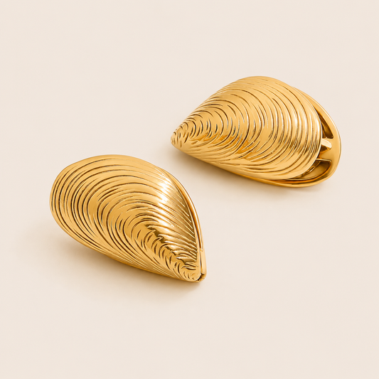 Gold ribbed shell-shaped clip earring with a glossy mussel-shell silhouette — Folie à Trois Cadaqués EARRINGS.