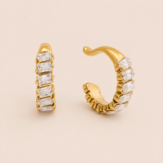 The Camogli EAR CUFF in a pair, a gold cuff set with a row of baguette-cut clear gems along the outer edge.