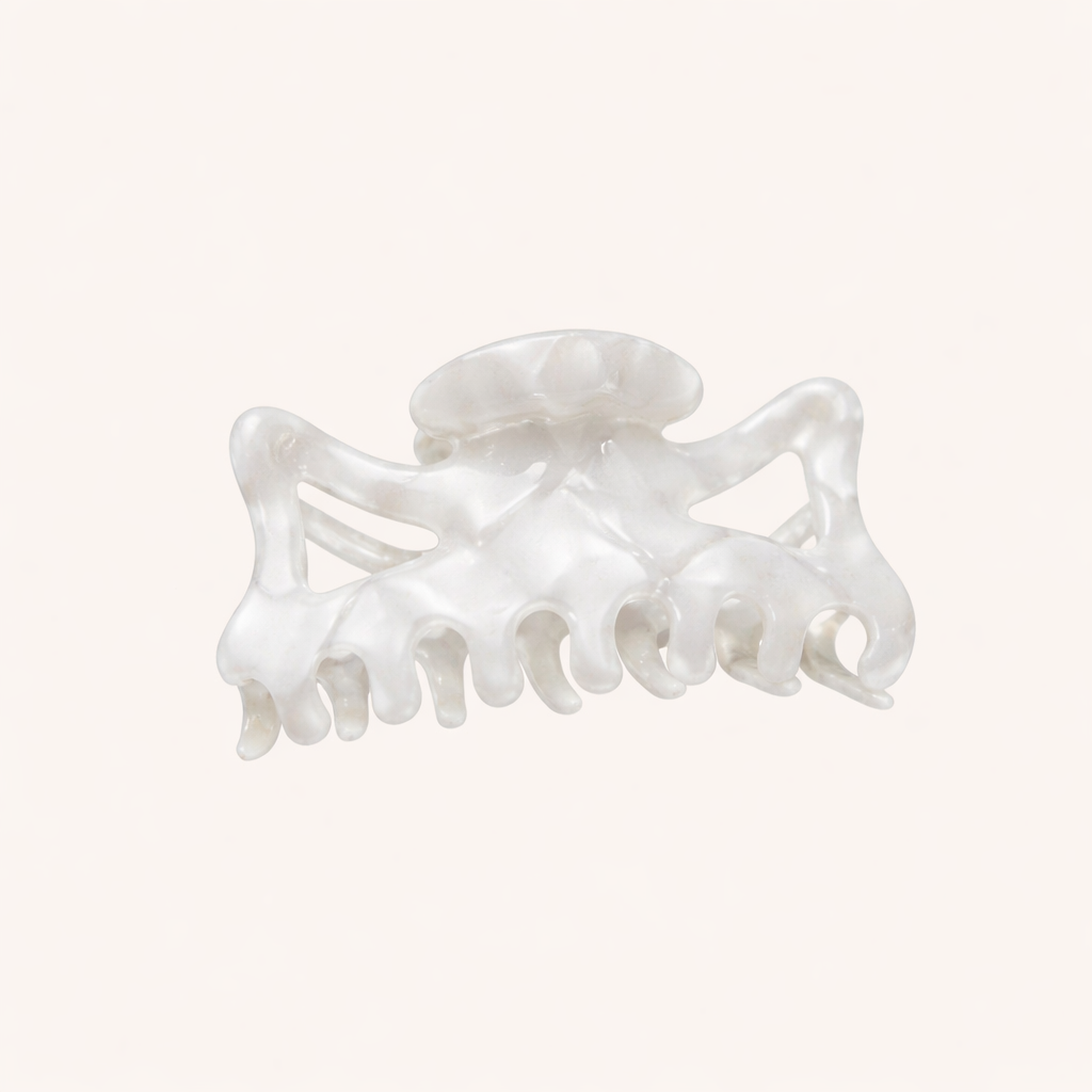 Solid pearly white acetate claw clip from the Capri HAIR CLIP collection, shown on a cream studio background.