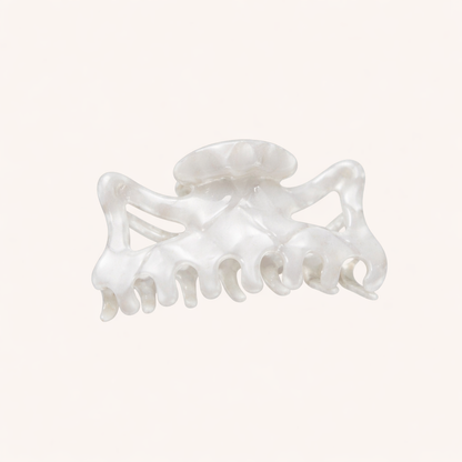 Solid pearly white acetate claw clip from the Capri HAIR CLIP collection, shown on a cream studio background.
