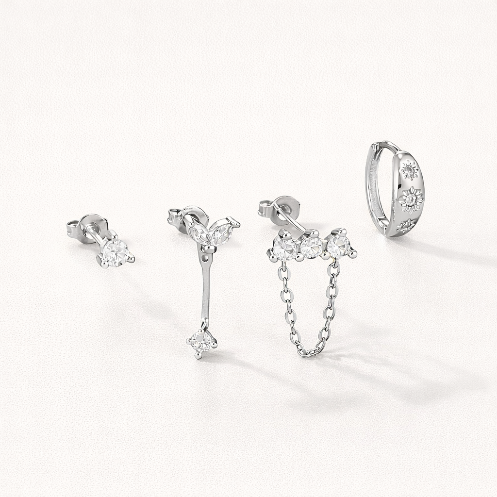 Capucine Set in silver tone, a crystal stud, a marquise leaf drop, a chain stud, and a star-set pave hoop.