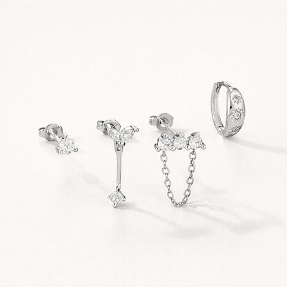 Capucine Set in silver tone, a crystal stud, a marquise leaf drop, a chain stud, and a star-set pave hoop.