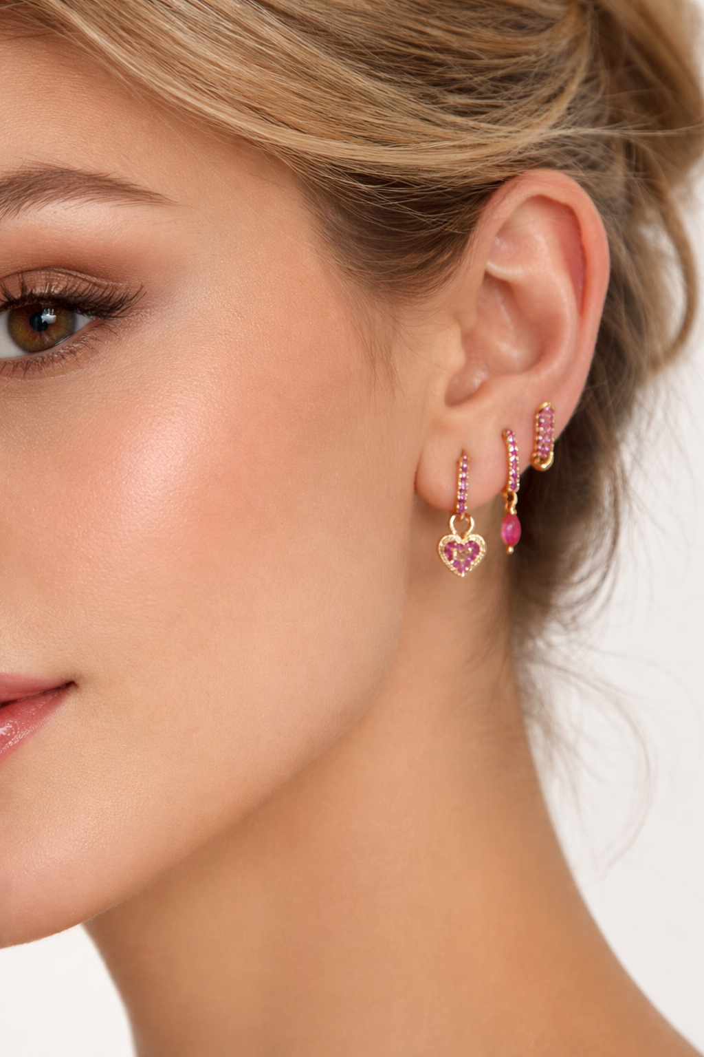 Worn along the ear, the Cara SET stacks three pink crystal hoops with heart and marquise charm details.