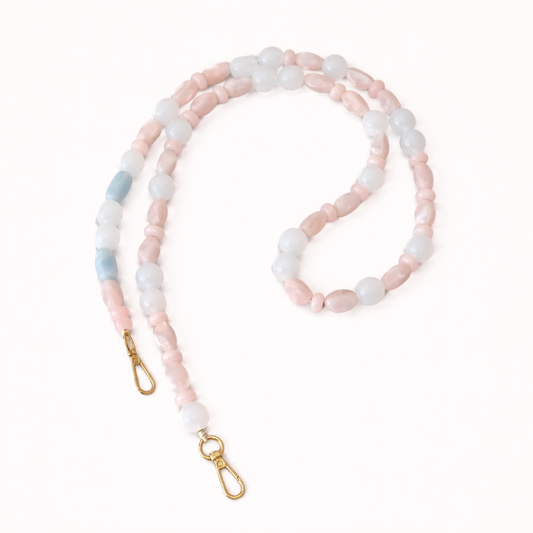 Pink, white, and blue stone beaded Celia long phone chain coiled flat with gold clasp ends.