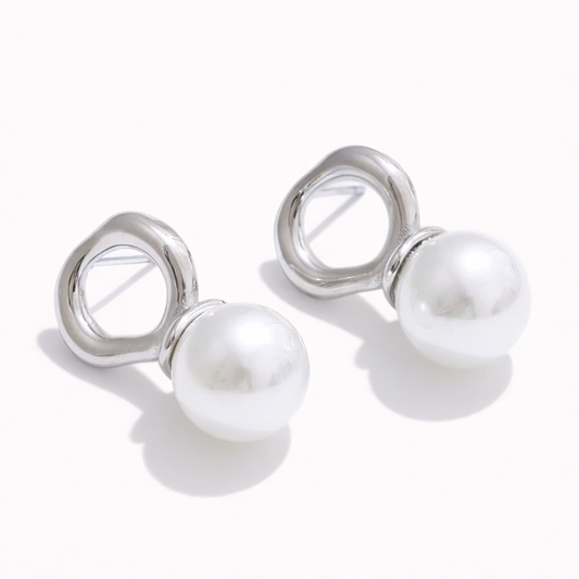 Cher Earrings in polished silver, an organic open-loop stud suspending a large lustrous pearl below.