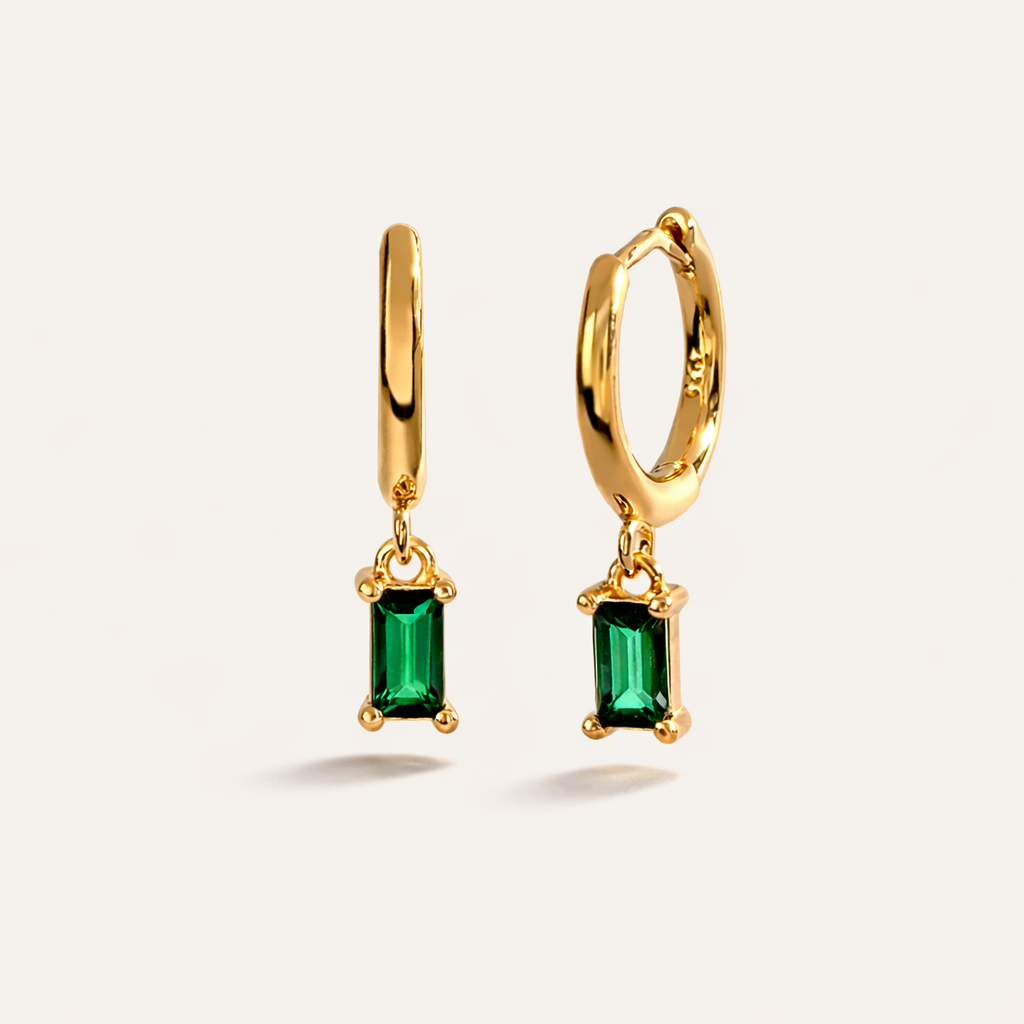 Classic Drop Earrings in gold with emerald-green crystals, the smooth hoop dropping a baguette-cut stone.