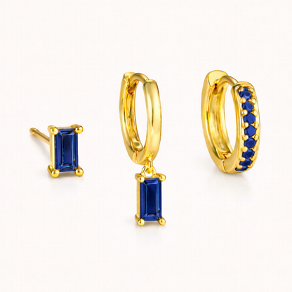 The Classic Drop SET in a sapphire blue colorway, featuring the baguette stud, dangle hoop, and pavé hoop in a studio shot.