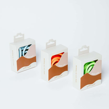 Three Colorful PHONE CORD packaging boxes showing blue and white striped, orange and bright green cords.