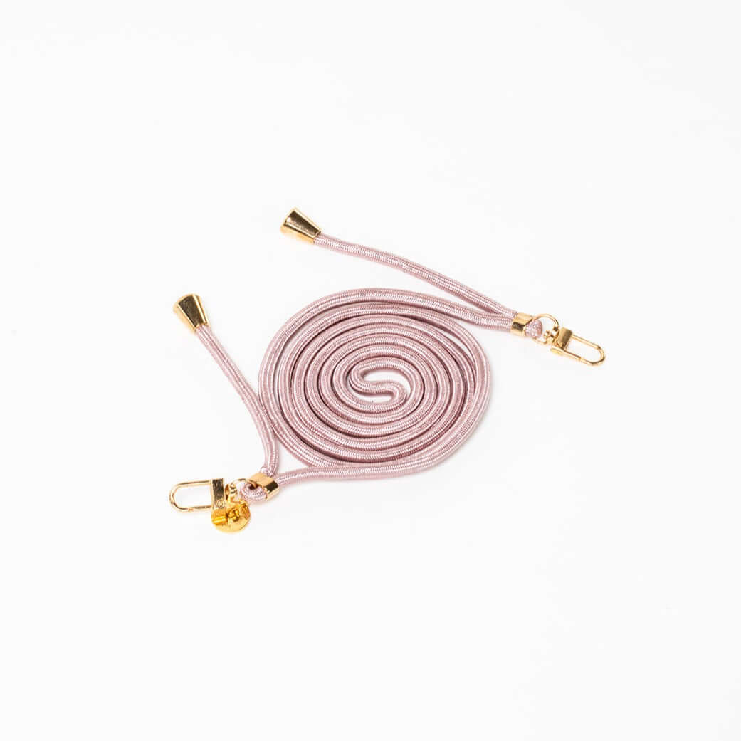 Dusty pink Colorful PHONE CORD coiled with gold-tone hardware on a white background.