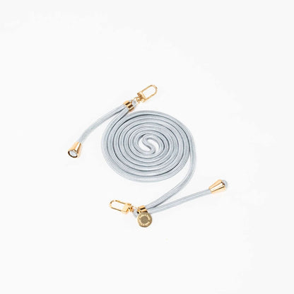 Light gray Colorful PHONE CORD coiled with gold-tone hardware on a white background.