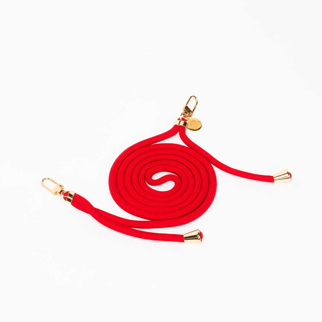 Red Colorful PHONE CORD coiled with shiny gold-tone hardware on a white background.