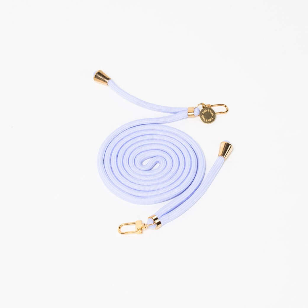Pale periwinkle Colorful PHONE CORD coiled with gold-tone hardware on a white background.