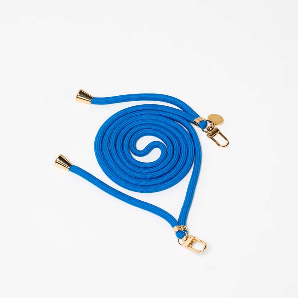 Blue Colorful PHONE CORD coiled neatly with gold-tone hardware on a white background.