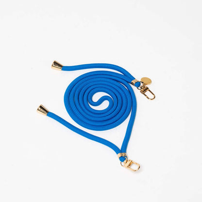 Blue Colorful PHONE CORD coiled neatly with gold-tone hardware on a white background.
