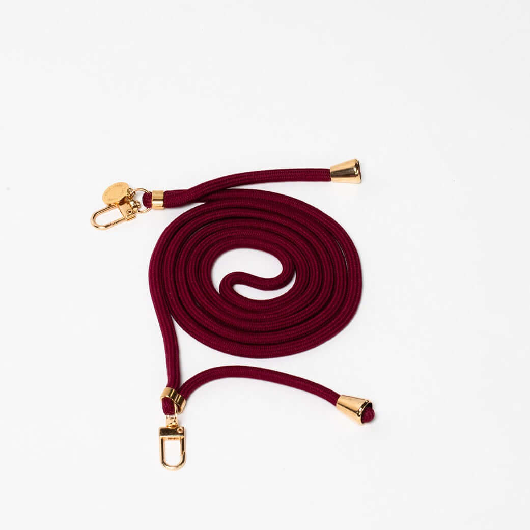 Burgundy Colorful PHONE CORD coiled with gold-tone hardware on a white background.