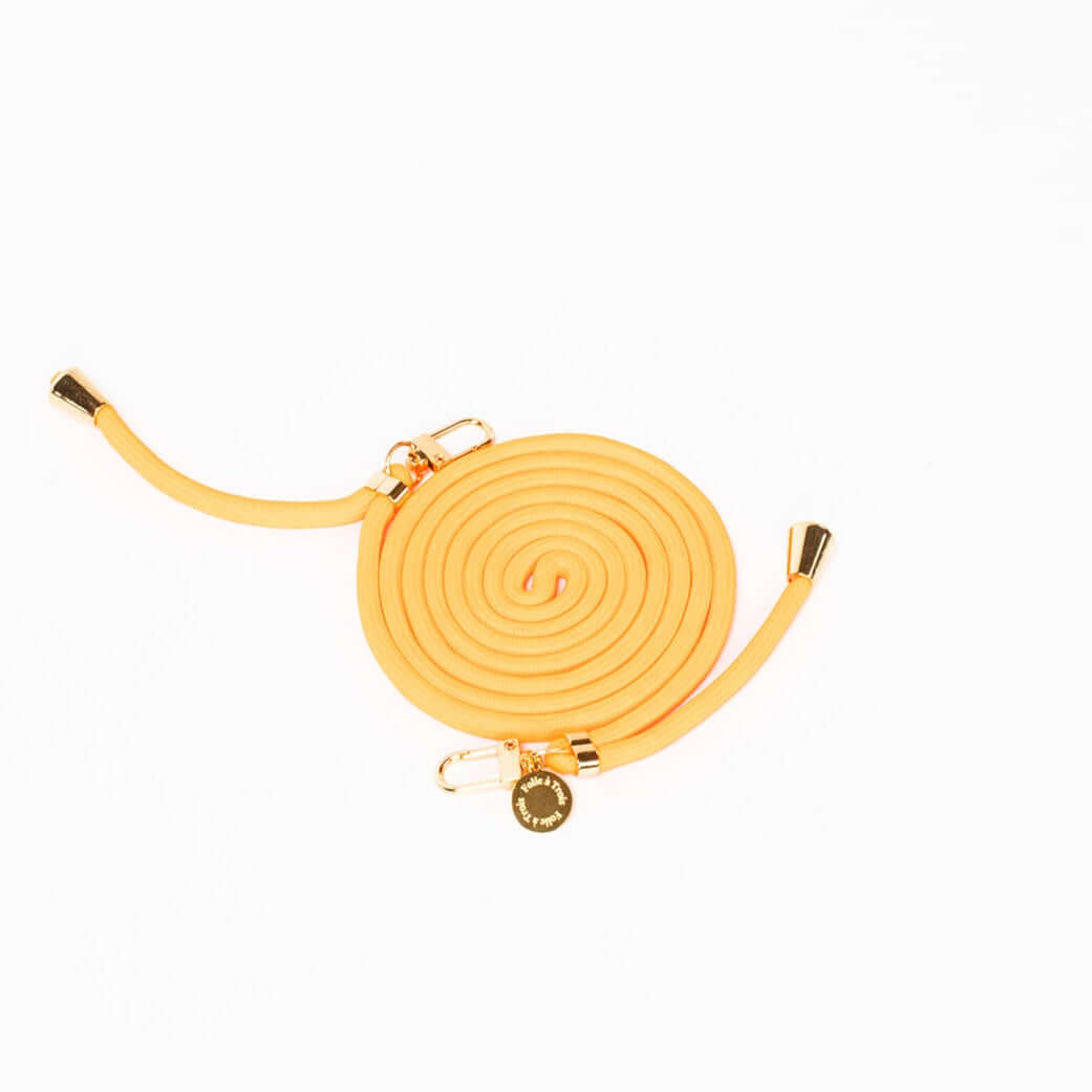 Mustard yellow Colorful PHONE CORD coiled with gold-tone hardware on a white background.