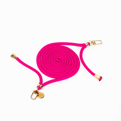 Hot pink Colorful PHONE CORD coiled with gold-tone hardware on a white background.