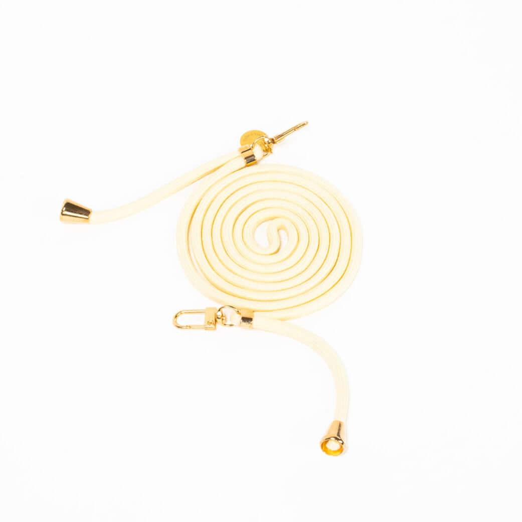 Cream Colorful PHONE CORD coiled neatly with gold-tone hardware on a white background.