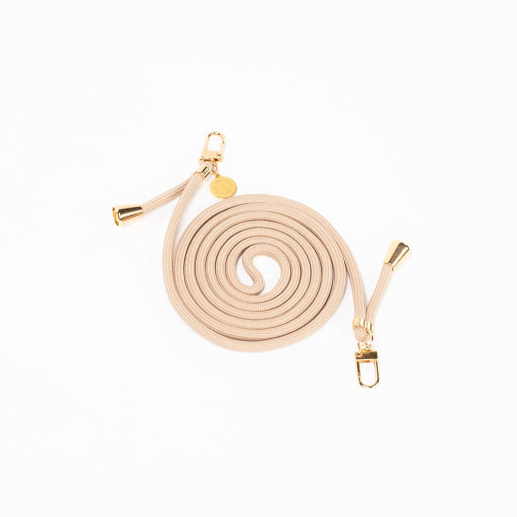 Beige Colorful PHONE CORD coiled neatly with gold-tone hardware on a white background.