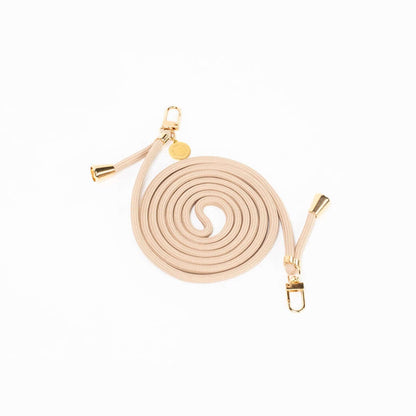 Beige Colorful PHONE CORD coiled neatly with gold-tone hardware on a white background.