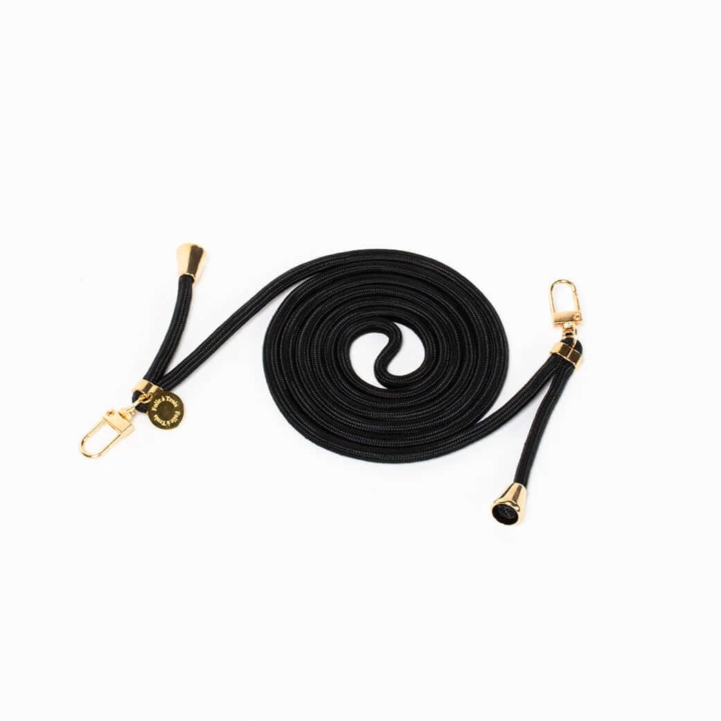 Black Colorful PHONE CORD coiled neatly with gold-tone hardware on a white background.