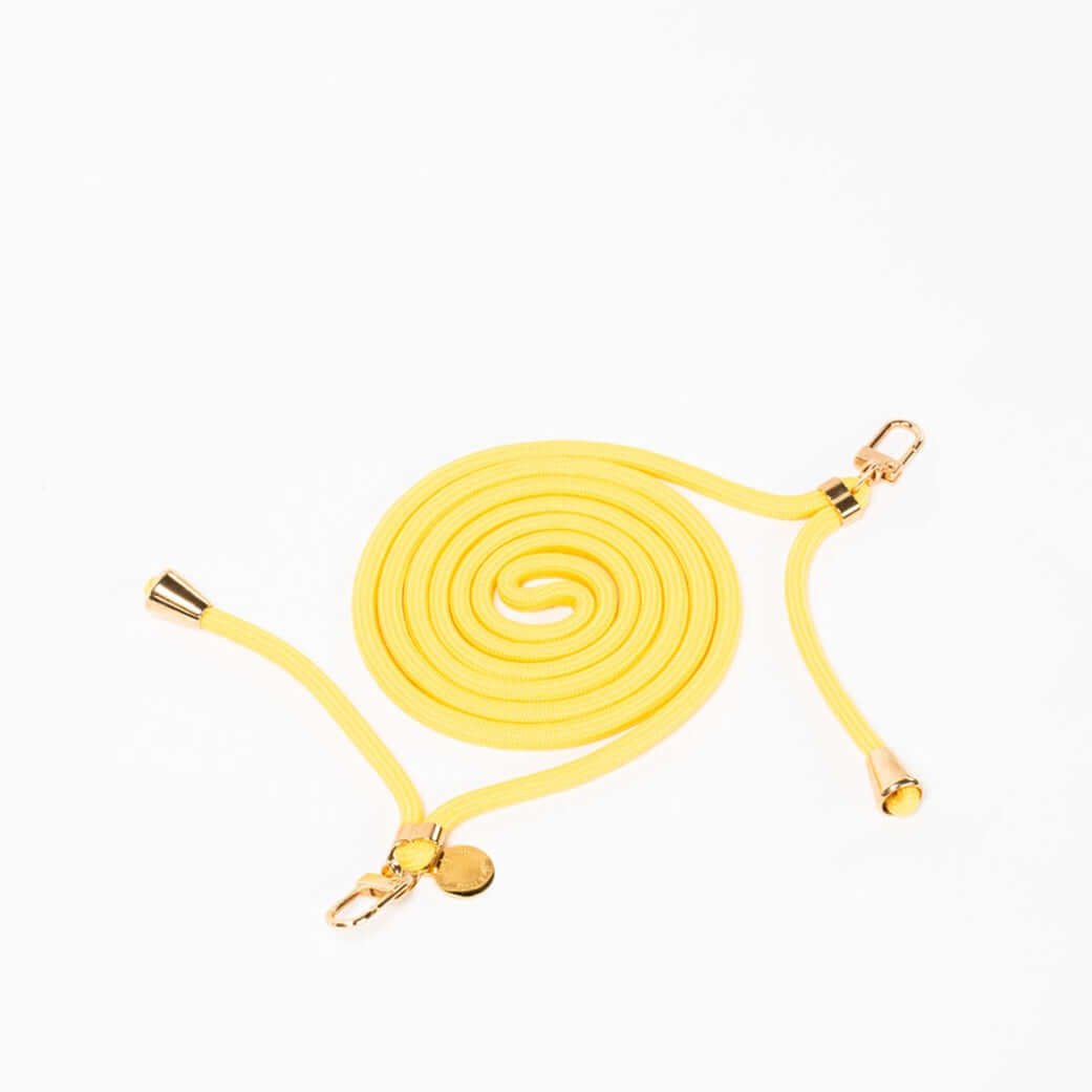 Yellow Colorful PHONE CORD coiled with gold-tone hardware on a white background.