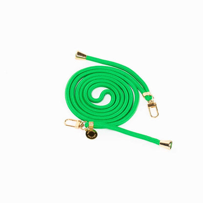 Bright green Colorful PHONE CORD coiled with gold-tone hardware on a white background.