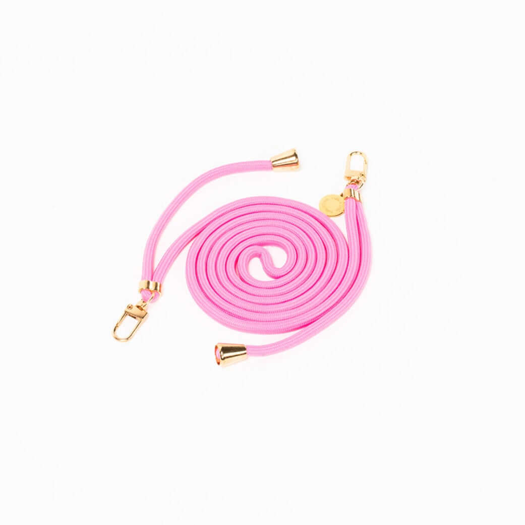 Bubblegum pink Colorful PHONE CORD coiled with gold-tone hardware on a white background.