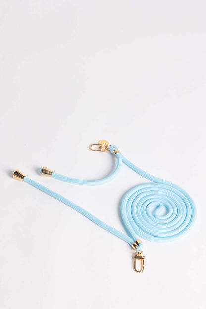 Pale blue Colorful PHONE CORD coiled with gold-tone hardware on a white background.