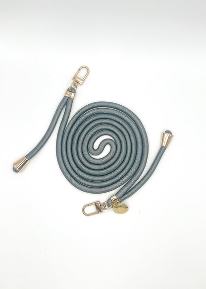 Gray-blue Colorful PHONE CORD coiled with gold-tone hardware on a white background.