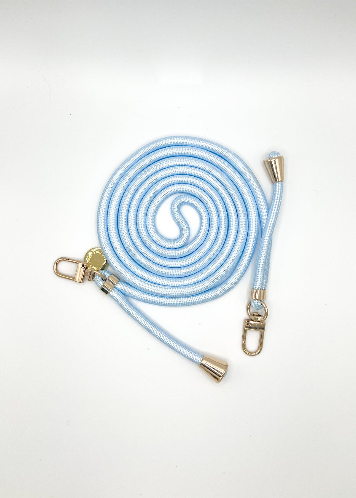 Pale blue and white Colorful PHONE CORD coiled with gold-tone hardware on a white background.