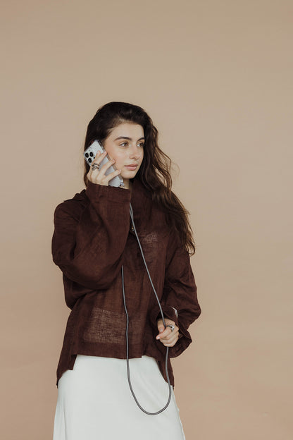 Model in a brown linen outfit on a phone call, dark gray Colorful PHONE CORD visible.