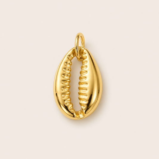 The Conch Shell CHARM in gold, a ribbed cowrie shell pendant, shown in close-up studio photography on cream.