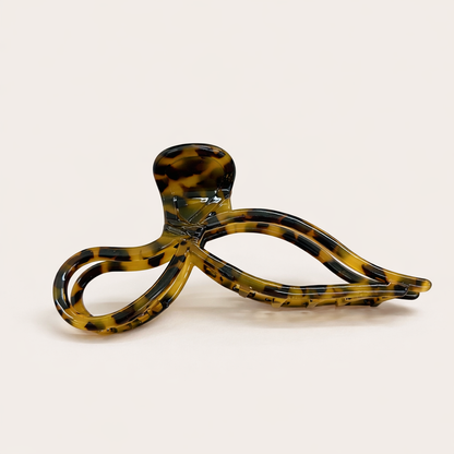 Coquette HAIR CLIP bow-shaped acetate claw clip in a solid amber tortoiseshell pattern, studio shot.