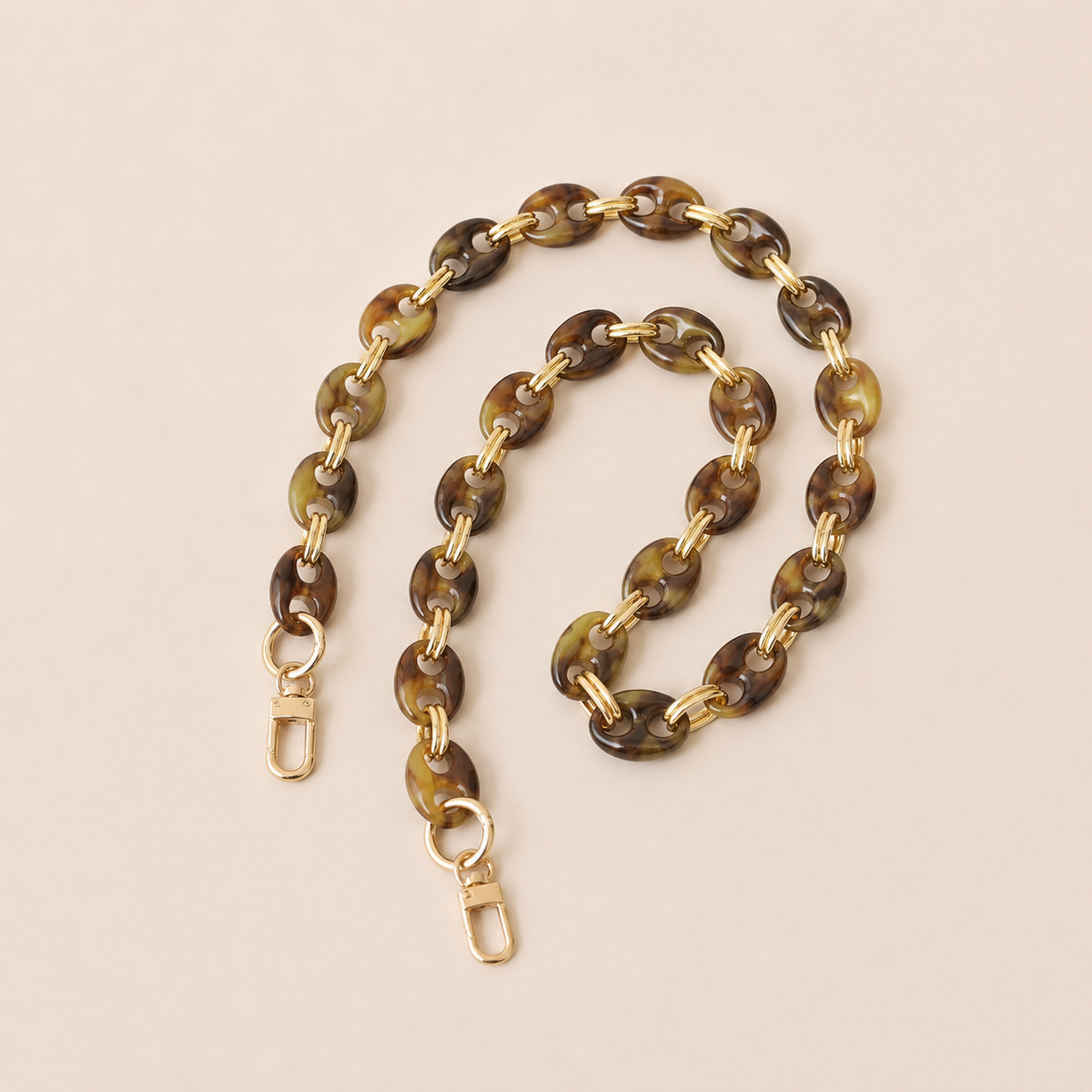 Olive brown tortoiseshell coin-link phone chain with gold connectors coiled on cream — Folie à Trois Corvin wholesale phone chain