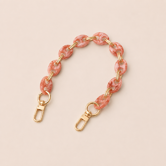 Round pink marbled coin-link phone chain with gold connectors on cream — Folie à Trois Corvin wholesale phone chain