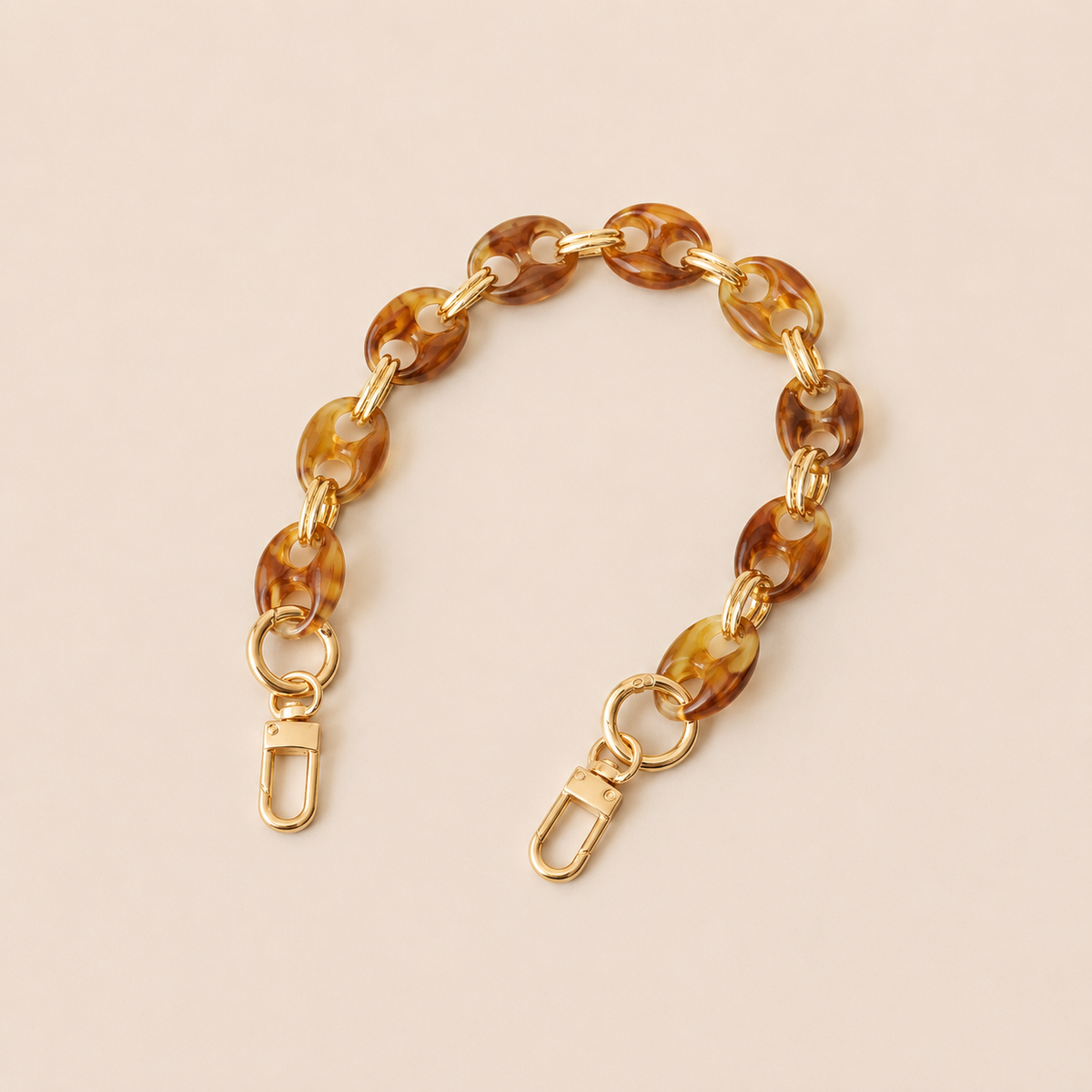 Round light brown tortoiseshell coin-link phone chain with gold connectors on cream — Folie à Trois Corvin wholesale phone chain