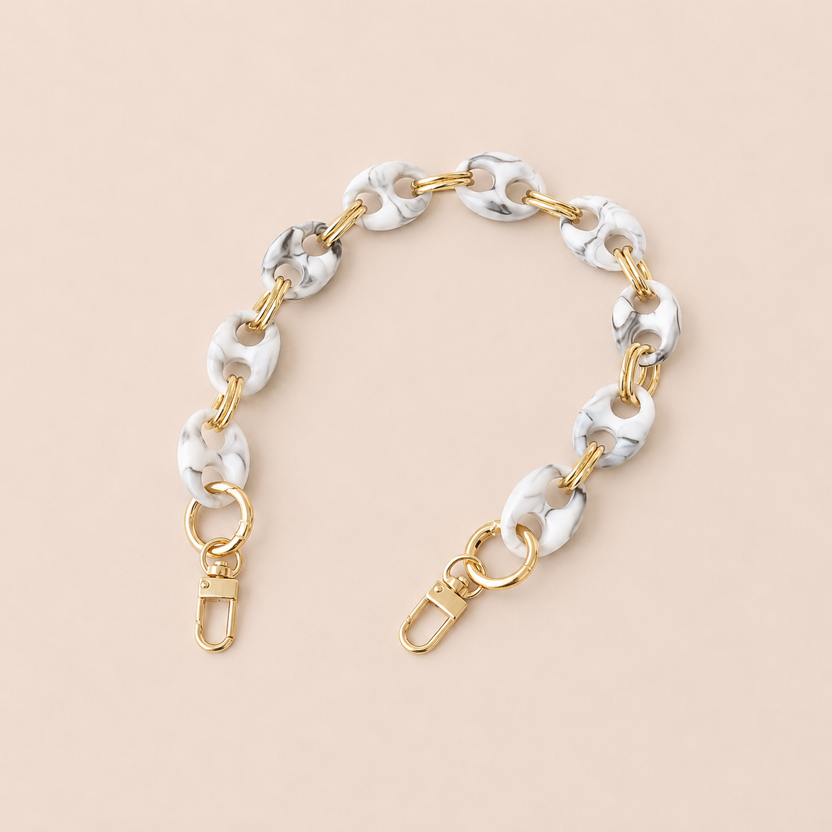 Round white and black marbled coin-link phone chain with gold connectors on cream — Folie à Trois Corvin wholesale phone chain
