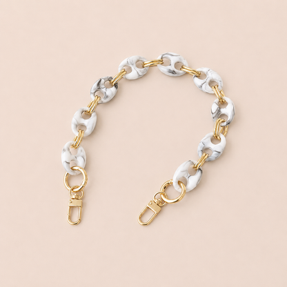 Round white and black marbled coin-link phone chain with gold connectors on cream — Folie à Trois Corvin wholesale phone chain