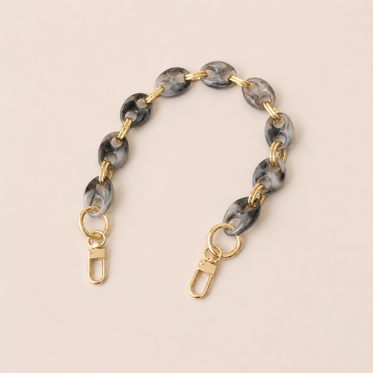 Round charcoal marbled coin-link phone chain with gold connectors on cream — Folie à Trois Corvin wholesale phone chain