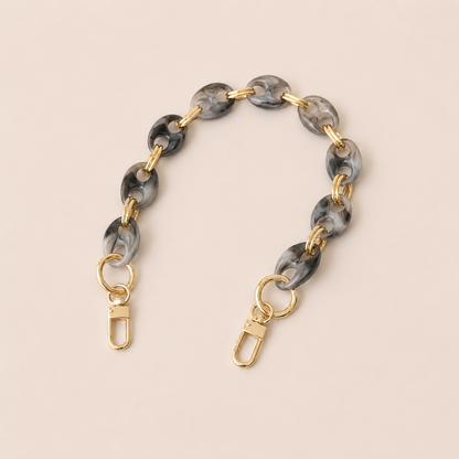 Round charcoal marbled coin-link phone chain with gold connectors on cream — Folie à Trois Corvin wholesale phone chain