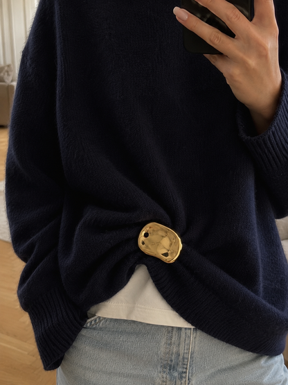 Model wears a gold Costa BROOCH cinching a navy sweater at the waist over jeans, mirror selfie — Folie à Trois