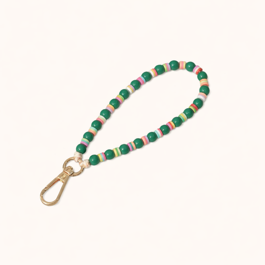 Green beaded Cove SHORT PHONE STRAP with colorful striped accent beads and a gold clasp, shown as a flat lay.