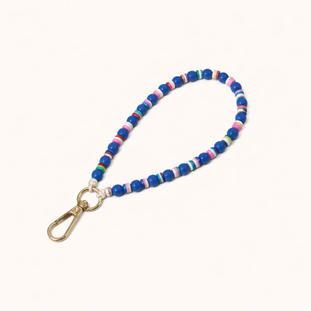 Blue beaded Cove SHORT PHONE STRAP with colorful striped accent beads and a gold clasp, shown as a flat lay.