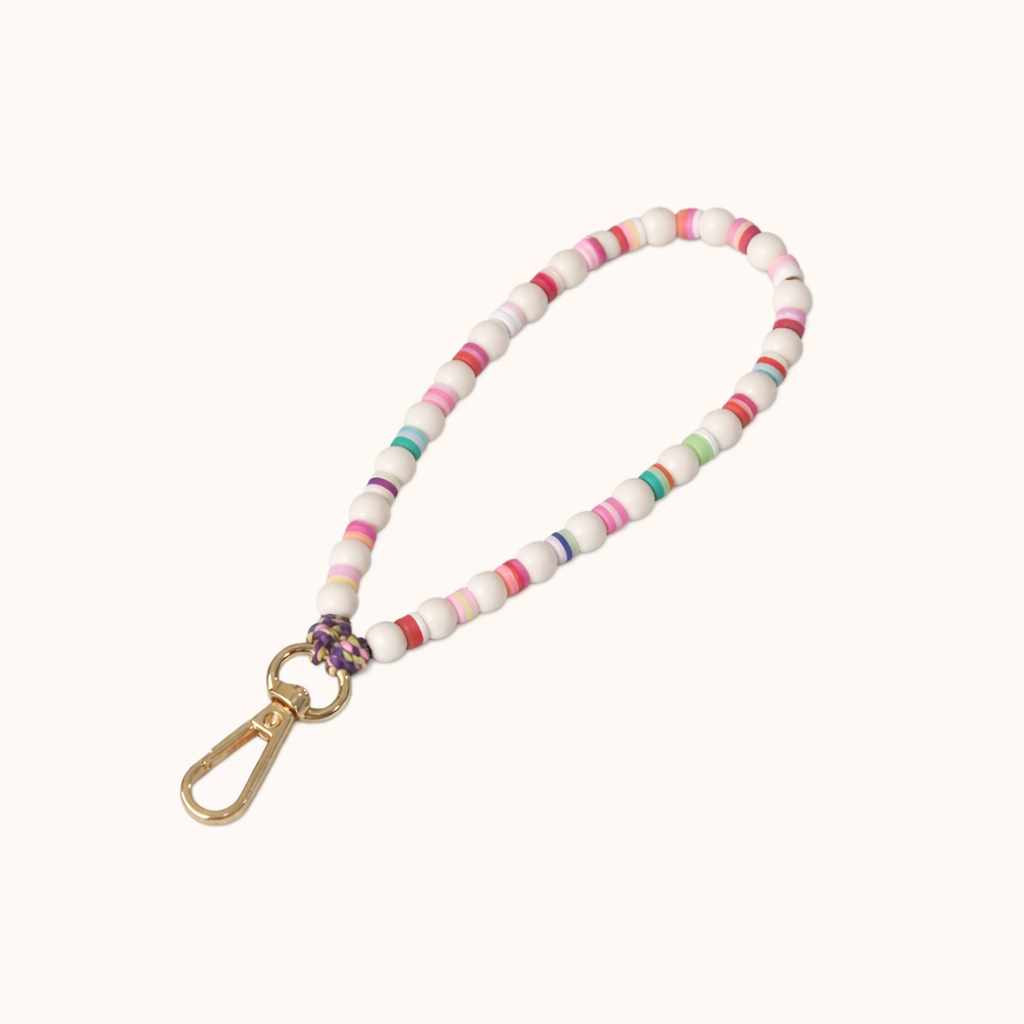 White beaded Cove SHORT PHONE STRAP with colorful striped accent beads and a gold clasp, shown as a flat lay.