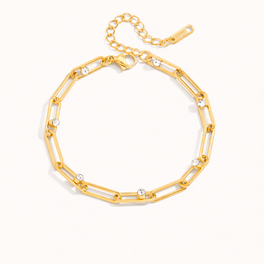 Crystal Vice BRACELET gold paperclip chain with round bezel-set crystal stations, studio flat-lay on a white background.